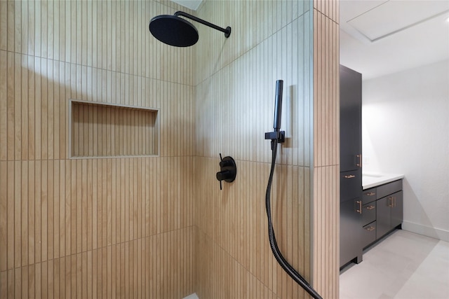 bathroom featuring vanity and tiled shower
