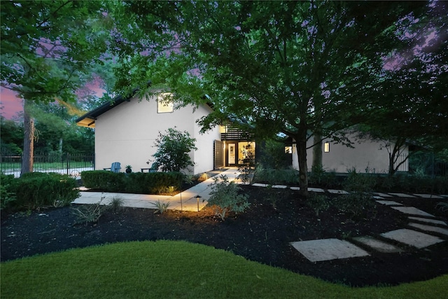 exterior space featuring fence and a lawn