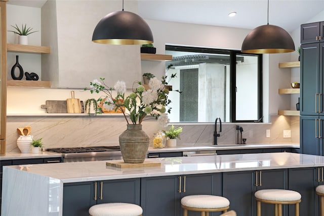 kitchen featuring backsplash, open shelves, a breakfast bar, and a sink
