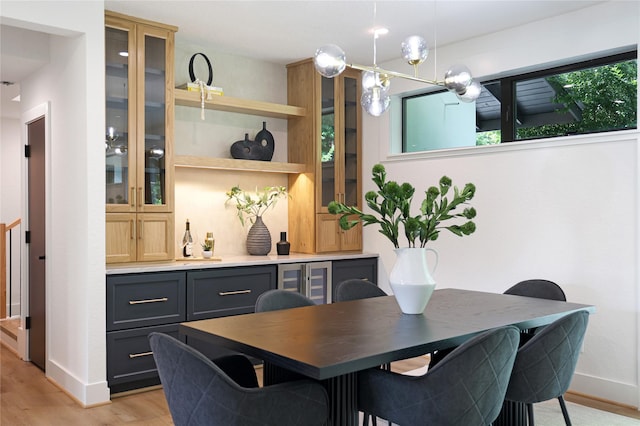 dining area featuring baseboards and light wood finished floors