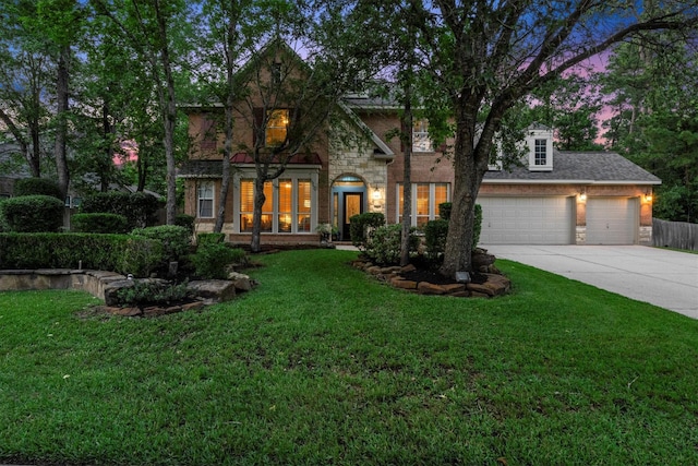 view of front of house featuring a lawn, driveway, and stone siding