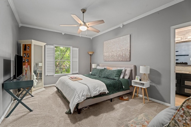 bedroom with crown molding, light colored carpet, a ceiling fan, baseboards, and ensuite bathroom