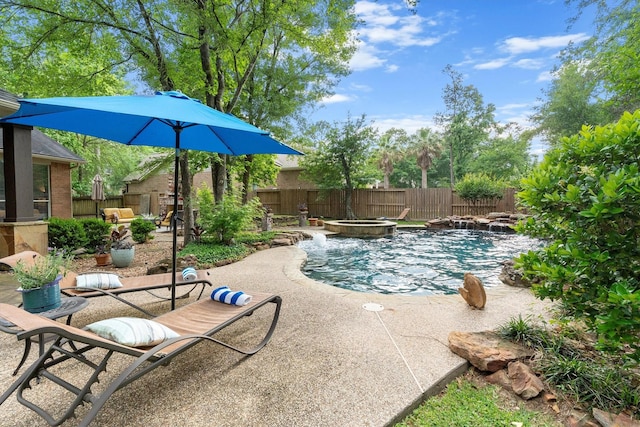 view of pool with a fenced backyard, a fenced in pool, an in ground hot tub, and a patio area