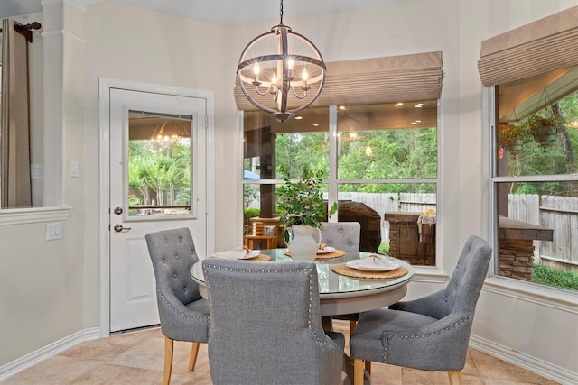 dining room featuring baseboards, a chandelier, and tile patterned flooring