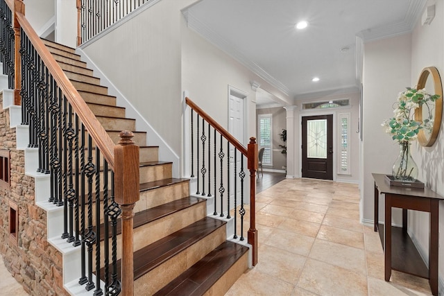foyer entrance with recessed lighting, ornamental molding, stairs, and light tile patterned floors