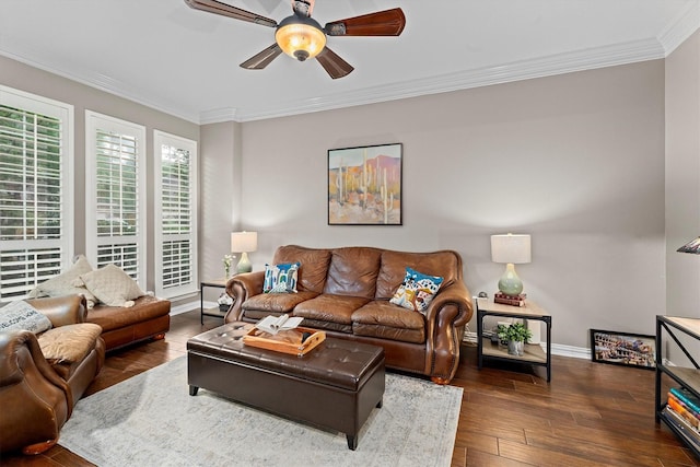 living room featuring ceiling fan, ornamental molding, baseboards, and hardwood / wood-style floors
