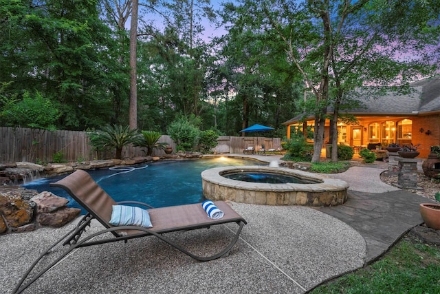 pool at dusk with a patio, a fenced backyard, an in ground hot tub, and a fenced in pool