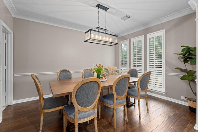 dining area featuring baseboards, ornamental molding, dark wood-type flooring, and visible vents