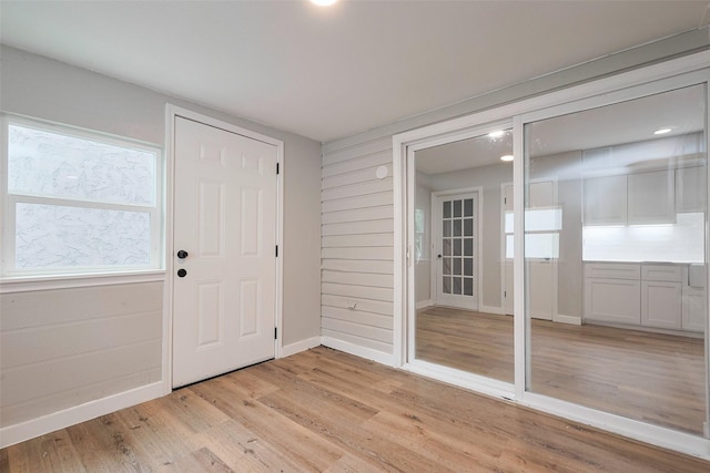 entrance foyer with baseboards and light wood finished floors