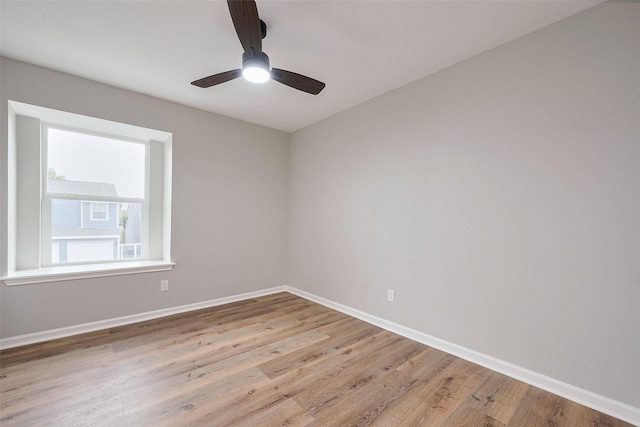 empty room featuring baseboards and light wood-style flooring