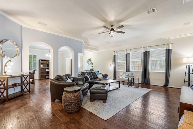 living room featuring crown molding, ceiling fan, arched walkways, visible vents, and hardwood / wood-style flooring
