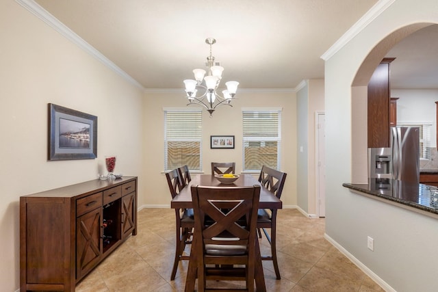 dining space featuring crown molding, light tile patterned flooring, an inviting chandelier, arched walkways, and baseboards