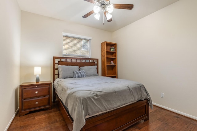 bedroom with baseboards, a ceiling fan, and dark wood-style flooring