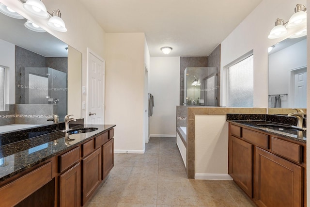 full bathroom with a garden tub, a sink, two vanities, and a shower stall