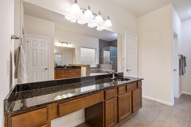 bathroom featuring vanity, baseboards, tile patterned floors, and a shower stall