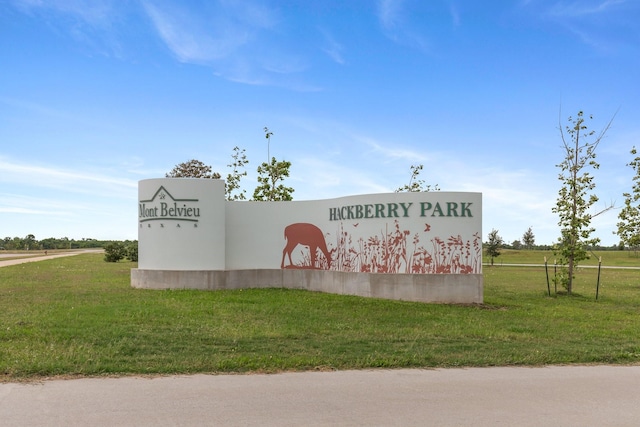 community / neighborhood sign with a yard