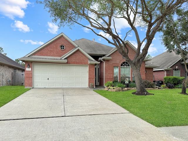 traditional-style house featuring brick siding, concrete driveway, a front yard, and an attached garage