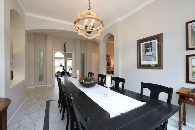 dining area featuring arched walkways, light marble finish flooring, ornamental molding, a chandelier, and baseboards