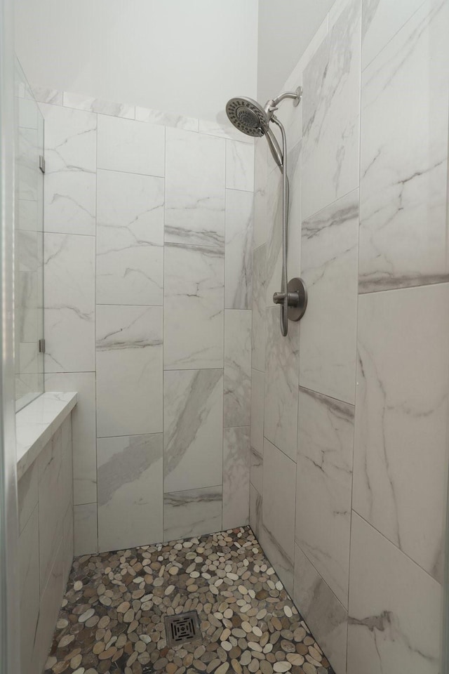 bathroom with a tile shower