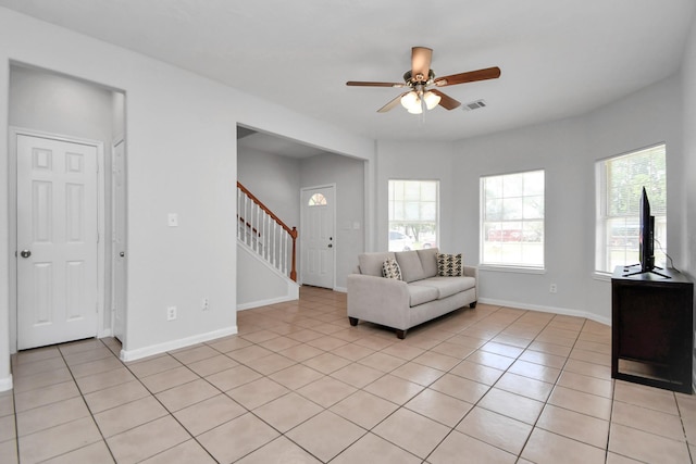 8102 Rhobell St, Houston, TX 77078 - living area featuring visible vents, a ceiling fan, stairs, and light tile patterned floors