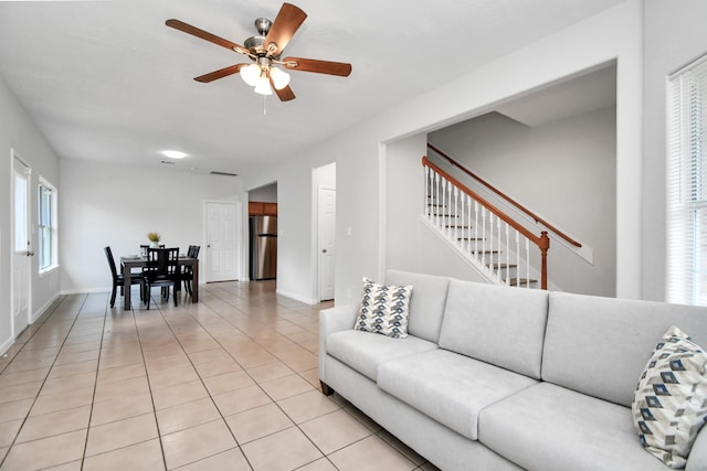 8102 Rhobell St, Houston, TX 77078 - living room with baseboards, ceiling fan, light tile patterned floors, and stairway