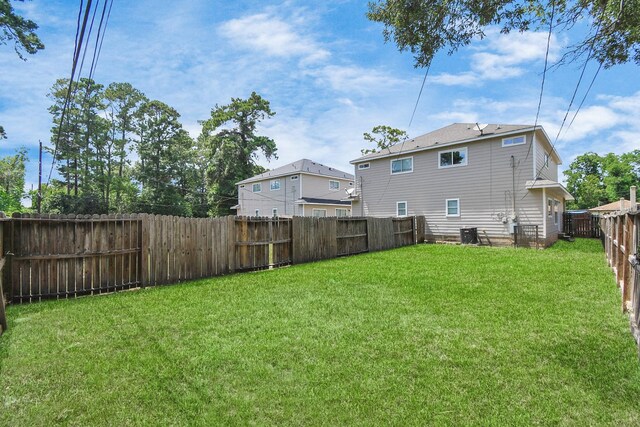 8102 Rhobell St, Houston, TX 77078 - view of yard with central AC unit and a fenced backyard