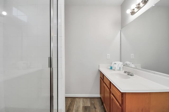 8102 Rhobell St, Houston, TX 77078 - bathroom with vanity, baseboards, a tile shower, and wood finished floors