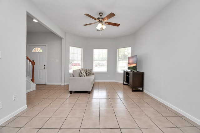 8102 Rhobell St, Houston, TX 77078 - sitting room with stairs, a ceiling fan, baseboards, and light tile patterned floors