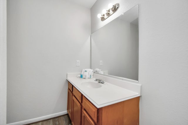 8102 Rhobell St, Houston, TX 77078 - bathroom featuring baseboards, wood finished floors, and vanity