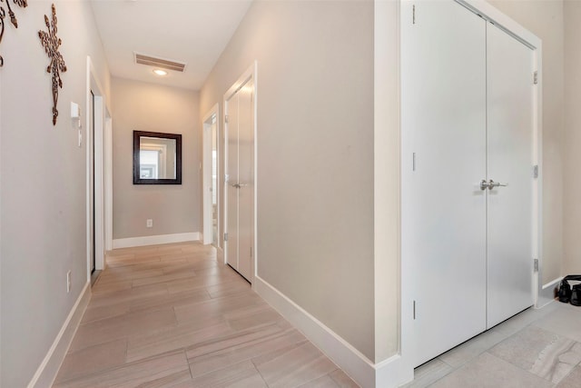 corridor with recessed lighting, baseboards, and visible vents