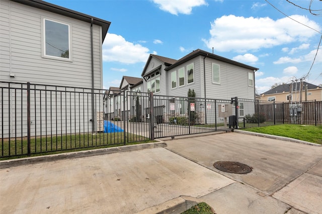 view of side of home featuring a residential view, a yard, and fence private yard