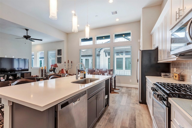 kitchen featuring visible vents, a sink, light countertops, and stainless steel appliances