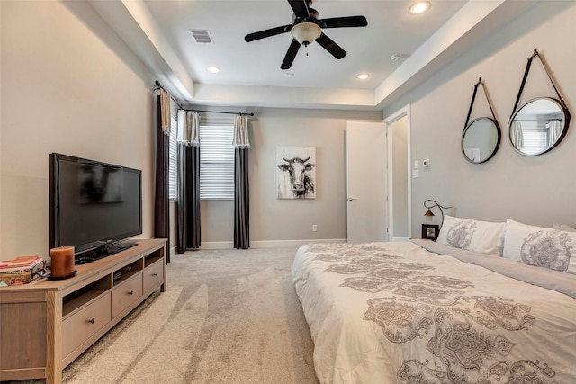 bedroom with visible vents, baseboards, recessed lighting, light colored carpet, and a raised ceiling