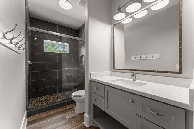 26111 Upper Beacon Pl, Montgomery, TX 77316 - full bath featuring vanity, a stall shower, toilet, and wood finished floors