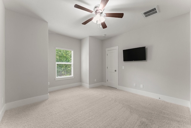 26111 Upper Beacon Pl, Montgomery, TX 77316 - unfurnished room featuring light colored carpet, baseboards, visible vents, and a ceiling fan