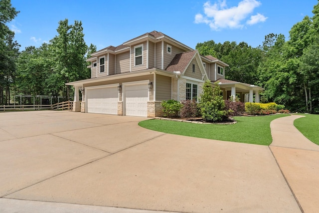 26111 Upper Beacon Pl, Montgomery, TX 77316 - craftsman-style house featuring driveway, a front yard, a garage, fence, and stone siding