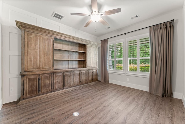 26111 Upper Beacon Pl, Montgomery, TX 77316 - unfurnished office featuring visible vents, baseboards, ceiling fan, and wood finished floors