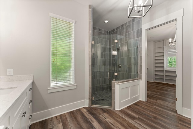 26111 Upper Beacon Pl, Montgomery, TX 77316 - full bathroom featuring plenty of natural light, a stall shower, wood finished floors, and a chandelier