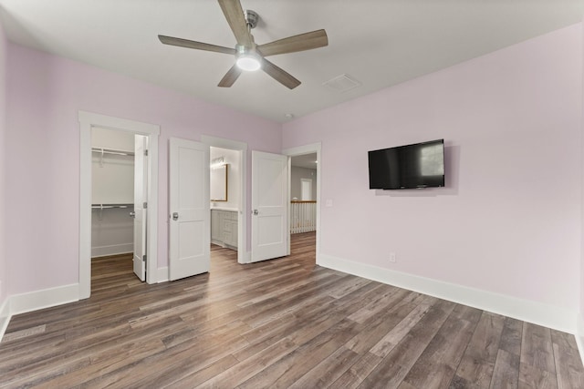26111 Upper Beacon Pl, Montgomery, TX 77316 - unfurnished bedroom featuring baseboards, wood finished floors, and visible vents