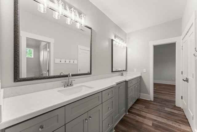 26111 Upper Beacon Pl, Montgomery, TX 77316 - full bathroom featuring a sink, baseboards, double vanity, and wood finished floors