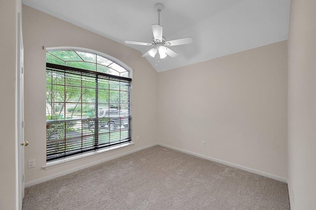 unfurnished room with baseboards, a ceiling fan, carpet, and vaulted ceiling