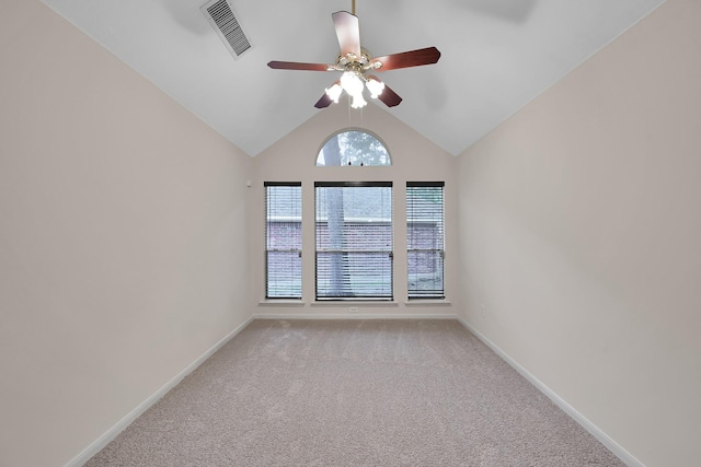 unfurnished room with visible vents, light carpet, baseboards, ceiling fan, and vaulted ceiling