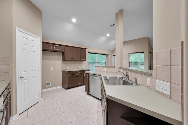 kitchen with dark brown cabinetry, a sink, dishwasher, light countertops, and decorative backsplash