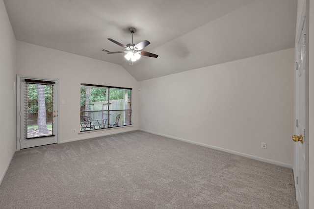 carpeted spare room with vaulted ceiling, baseboards, a ceiling fan, and visible vents