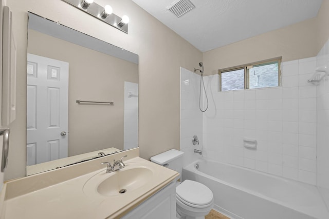 bathroom with visible vents, shower / tub combination, toilet, and vanity