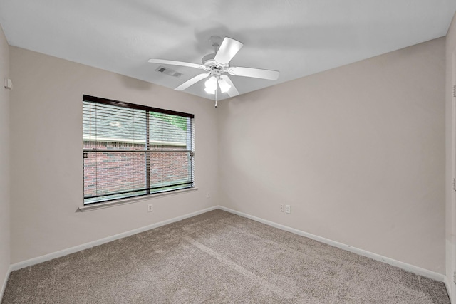 empty room featuring baseboards, visible vents, ceiling fan, and carpet