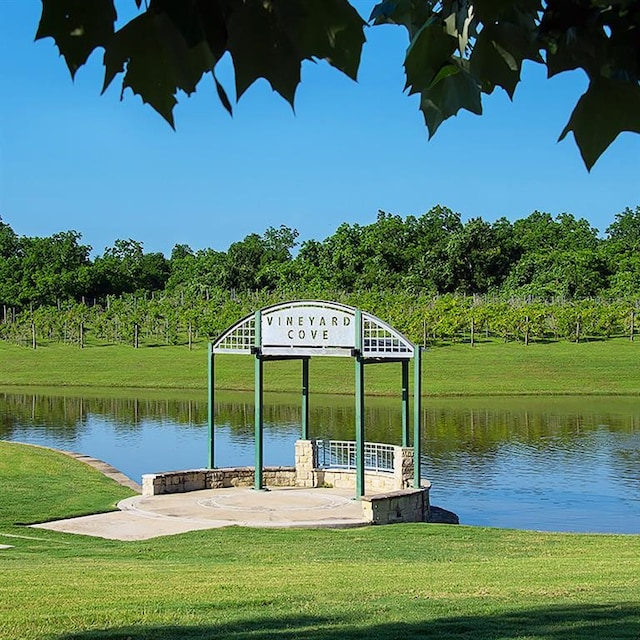 dock area featuring a lawn, a water view, and a gazebo