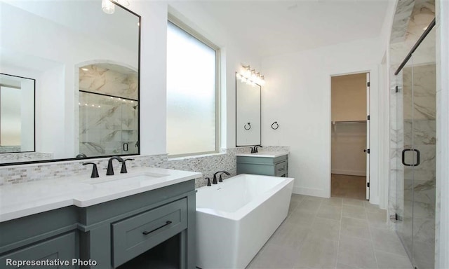 full bathroom featuring a sink, a marble finish shower, and plenty of natural light