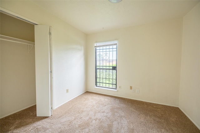 unfurnished bedroom with carpet floors and baseboards