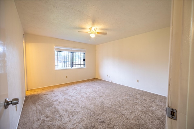 carpeted spare room featuring a ceiling fan and a textured ceiling